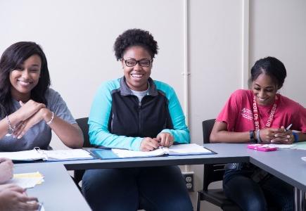 Three women smiling during SI